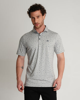 Man wearing a gray patterned polo shirt against a plain background