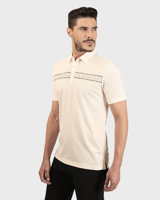 Man wearing a beige short-sleeve shirt with a subtle pattern on a white background