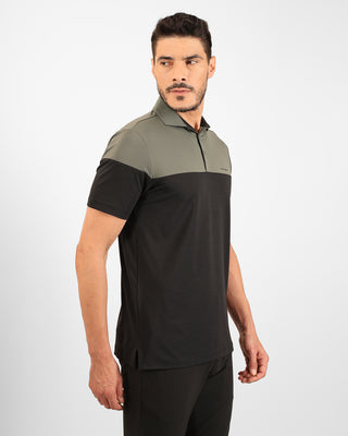 Man wearing a black and green polo shirt on a white background