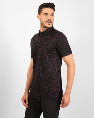 Man wearing a black patterned shirt on a white background